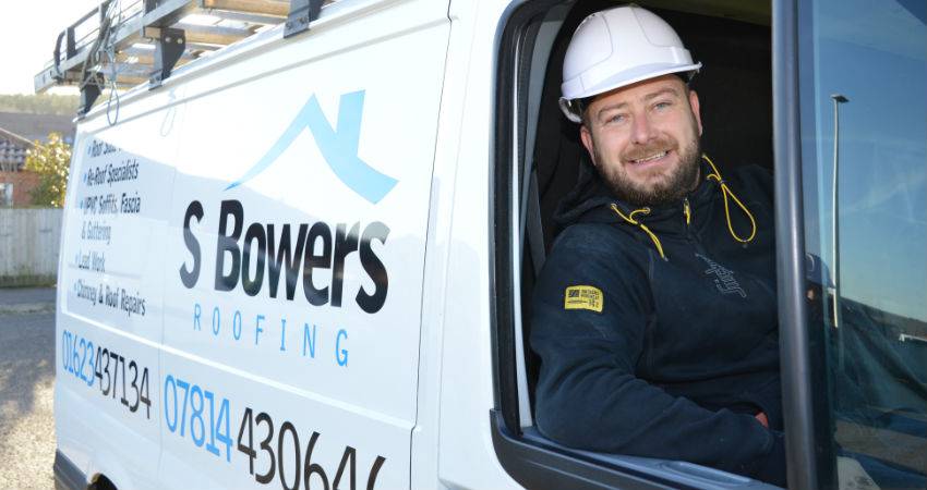 s bowers smiling in a van